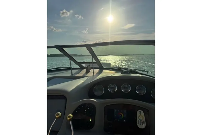 Slide: The Image of 2007 Sea Ray 320 Sundancer dashboard view with sunlit ocean horizon. - 34
