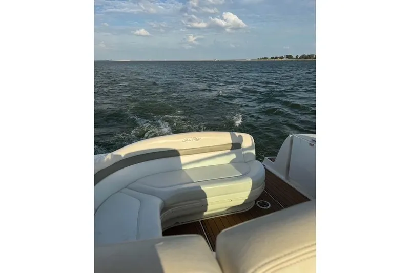 Slide: The Image of 2007 Sea Ray 320 Sundancer cruising on open water under a clear sky. - 35