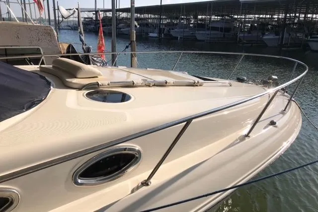 Slide: The Image of 2007 Sea Ray 320 Sundancer yacht docked at marina, showcasing sleek design and sun deck. - 7