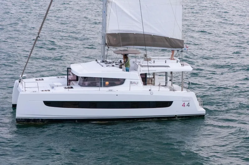 Slide: The Image of 2023 Bali 4.4 catamaran sailing on open water, showcasing sleek design and spacious deck. - 1