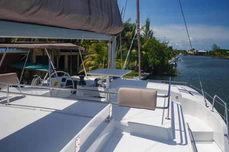 Slide: The Image of 2023 Bali 4.4 yacht on a serene canal with lush greenery. - 14