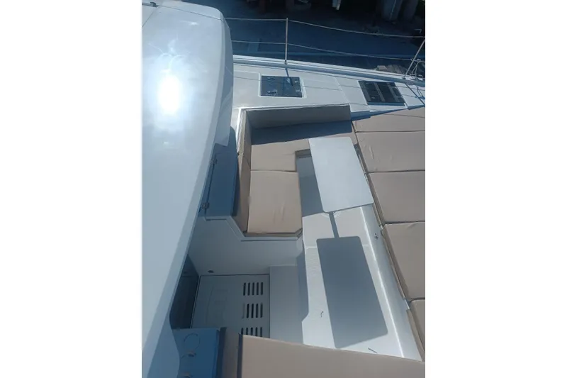 Slide: The Image of 2023 Bali 4.4 yacht deck with seating and table, featuring modern design and sunlit surfaces. - 16