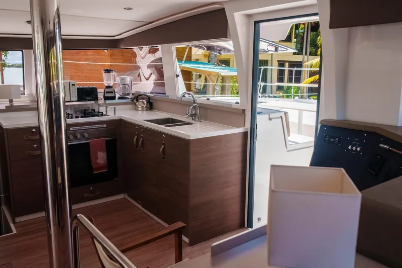 Slide: The Image of Modern kitchen interior on 2023 Bali 4.4 yacht, featuring sleek appliances and wooden cabinetry. - 22