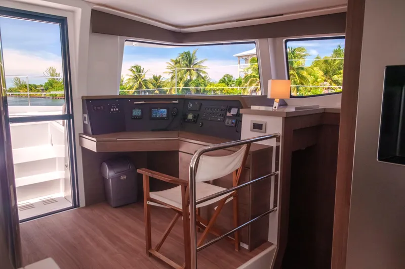 Slide: The Image of Modern Bali 4.4 yacht interior with navigation controls, tropical view, and elegant seating, 2023 model. - 25