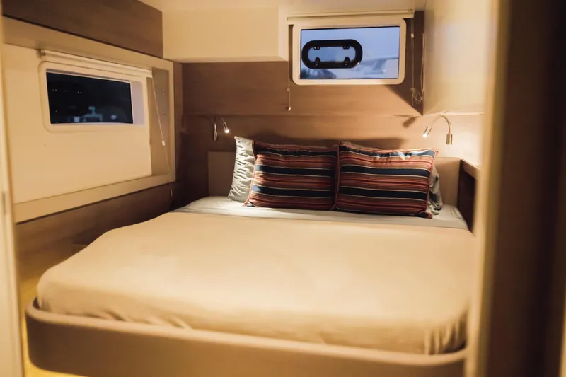 Slide: The Image of Cozy bedroom in 2023 Bali 4.4 yacht with striped pillows and ambient lighting. - 29