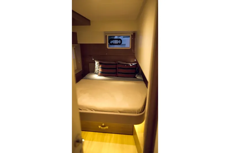 Slide: The Image of Cozy cabin interior of 2023 Bali 4.4 yacht with striped pillows and small window. - 30