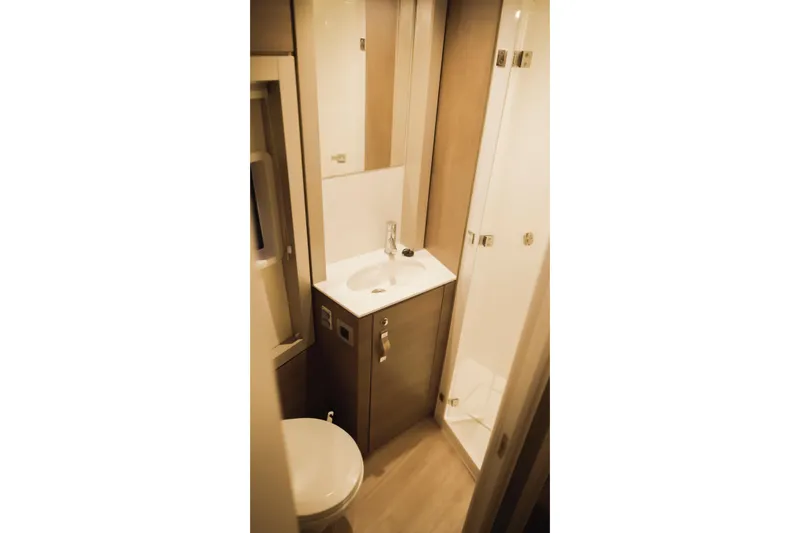 Slide: The Image of Compact bathroom in 2023 Bali 4.4 model, featuring sink, toilet, and shower. - 35