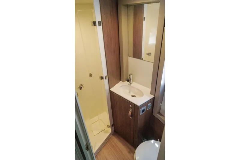 Slide: The Image of Compact bathroom in 2023 Bali 4.4 model with shower, sink, and mirror. - 36