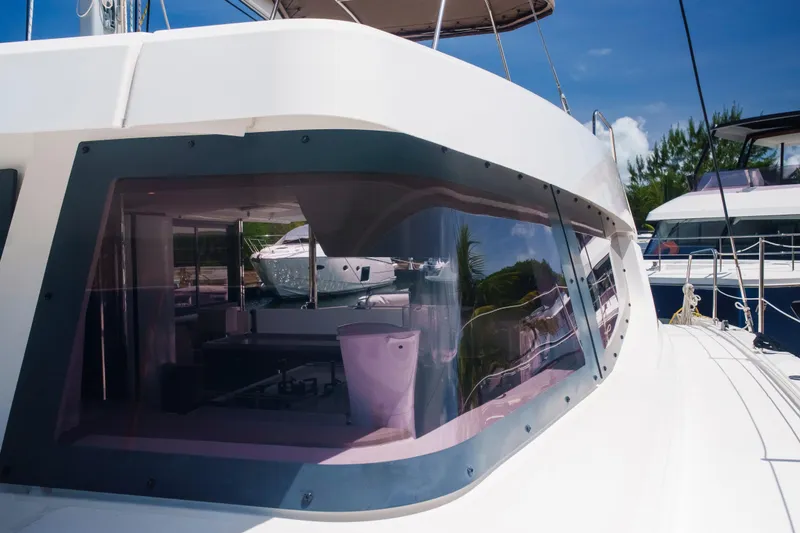 Slide: The Image of 2023 Bali 4.4 yacht with sleek design and reflective windows in marina setting. - 39