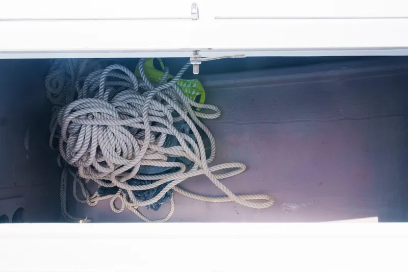 Slide: The Image of Storage compartment with coiled rope in a 2023 Bali 4.4 model boat. - 42