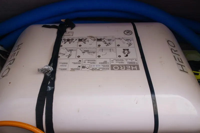 Slide: The Image of Inflatable life raft with instructions, secured by straps, on a Bali 4.4, 2023 model. - 47