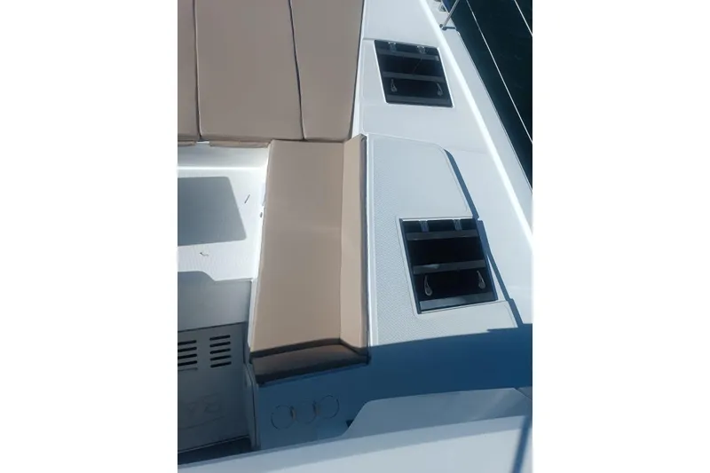 Slide: The Image of 2023 Bali 4.4 yacht deck with beige seating and storage compartments. - 54