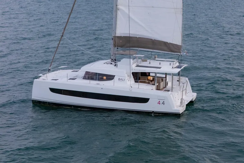 Slide: The Image of 2023 Bali 4.4 catamaran sailing on open water, showcasing sleek design and spacious deck. - 59