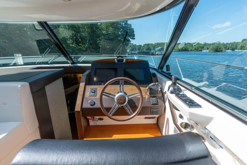 Slide: The Image of Helm of 2015 Tiara Yachts C44 Coupe with scenic water view. - 10