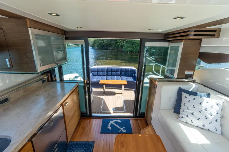 Slide: The Image of Luxurious interior of 2015 Tiara Yachts C44 Coupe with elegant seating and scenic water view. - 12