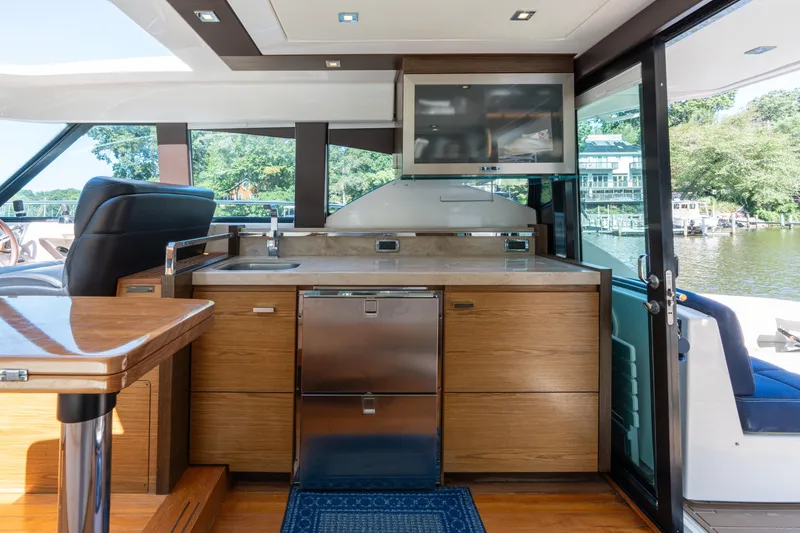 Slide: The Image of Luxurious interior of 2015 Tiara Yachts C44 Coupe with modern kitchen and scenic view. - 13