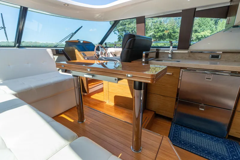 Slide: The Image of Interior of 2015 Tiara Yachts C44 Coupe, featuring luxurious seating and modern helm. - 14