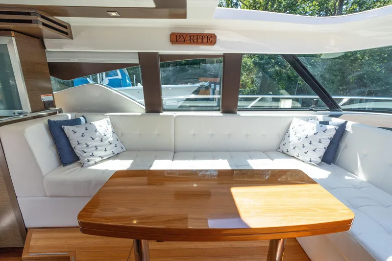 Slide: The Image of Luxurious interior of 2015 Tiara Yachts C44 Coupe with elegant seating and wooden table. - 16