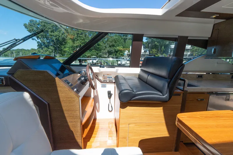 Slide: The Image of Interior of 2015 Tiara Yachts C44 Coupe with luxurious helm and seating. - 17