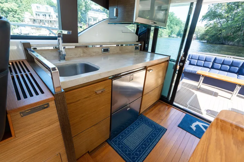 Slide: The Image of Luxurious interior of 2015 Tiara Yachts C44 Coupe with modern kitchen and scenic view. - 20