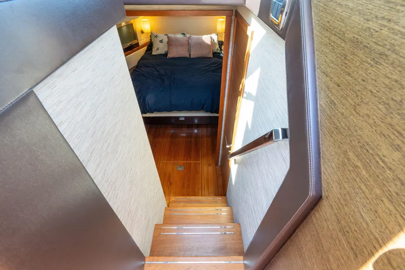 Slide: The Image of Staircase leading to cozy bedroom in 2015 Tiara Yachts C44 Coupe. - 24