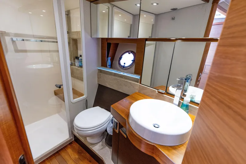 Slide: The Image of Luxurious bathroom in 2015 Tiara Yachts C44 Coupe with modern fixtures and wooden accents. - 27