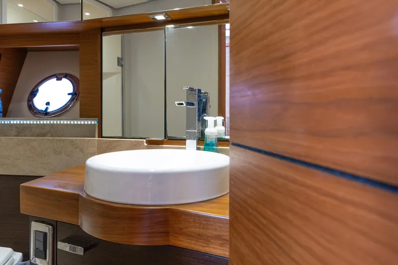 Slide: The Image of Luxurious bathroom interior of 2015 Tiara Yachts C44 Coupe with modern sink and wooden accents. - 28