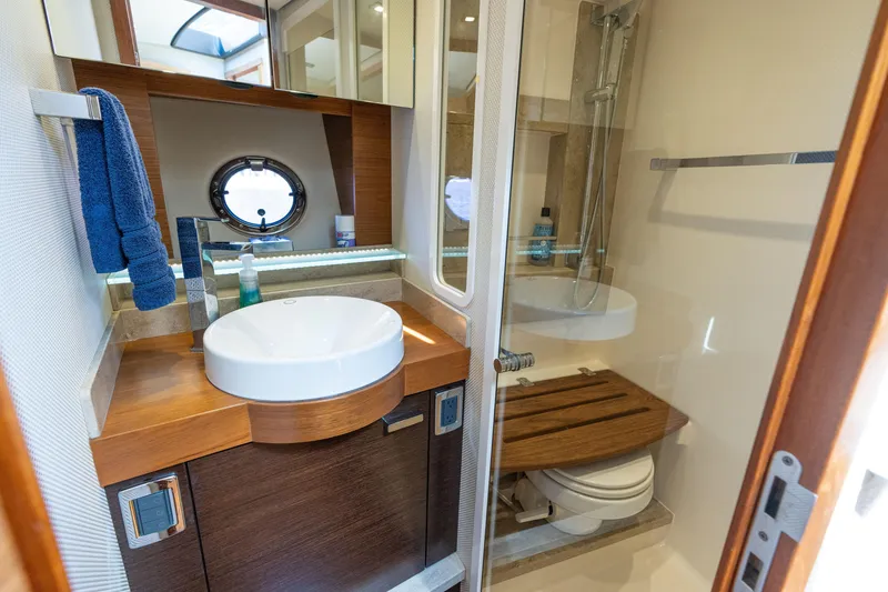 Slide: The Image of Luxurious bathroom in 2015 Tiara Yachts C44 Coupe with modern fixtures and porthole window. - 34