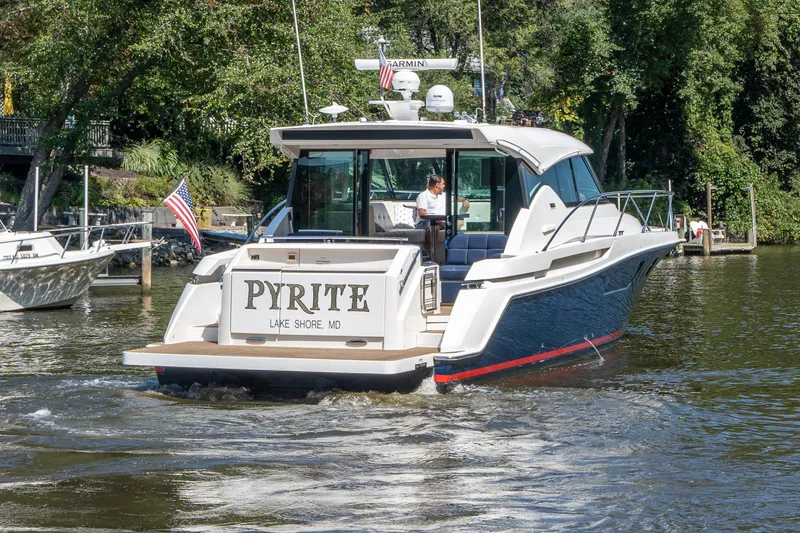 Slide: The Image of 2015 Tiara Yachts C44 Coupe cruising on a scenic waterway. - 4