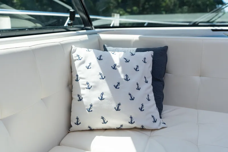 Slide: The Image of Cushioned seating on 2015 Tiara Yachts C44 Coupe with anchor-patterned pillow. - 43