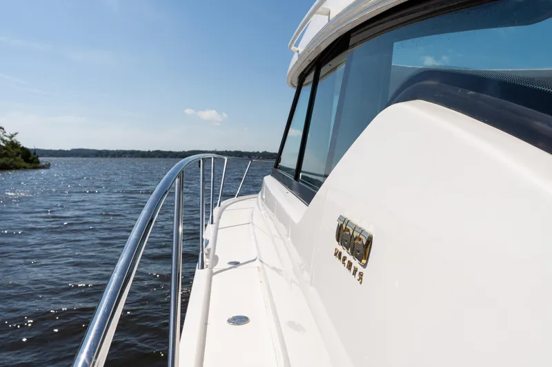 Slide: The Image of 2015 Tiara Yachts C44 Coupe cruising on a sunny day, showcasing sleek design. - 44