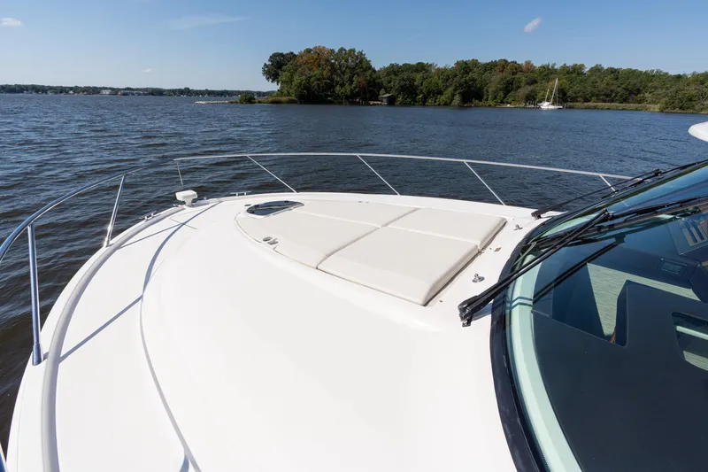 Slide: The Image of 2015 Tiara Yachts C44 Coupe on serene lake with lush shoreline. - 45