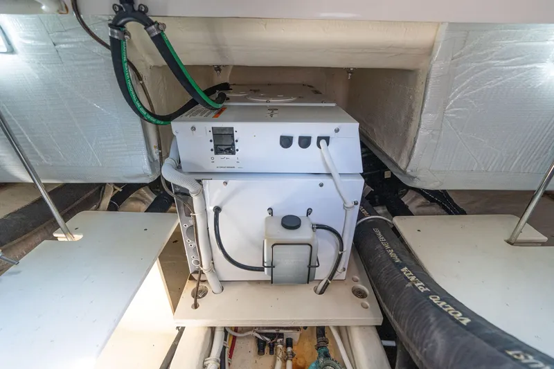 Slide: The Image of Engine room of 2015 Tiara Yachts C44 Coupe, showcasing mechanical components and wiring. - 55