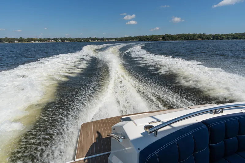 Slide: The Image of Wake of 2015 Tiara Yachts C44 Coupe on a sunny day, cruising on open water. - 56