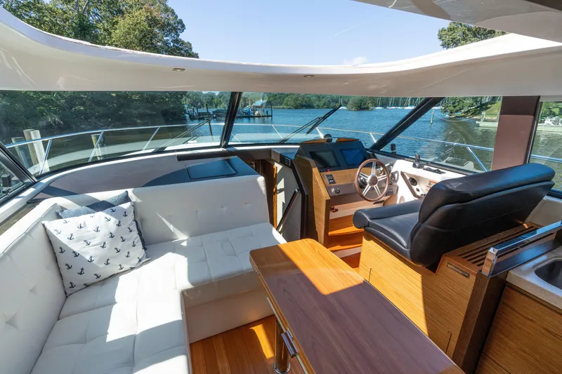 Slide: The Image of Luxurious interior of 2015 Tiara Yachts C44 Coupe with helm, seating, and scenic water view. - 8