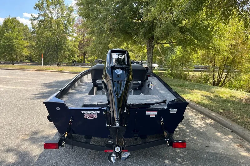 Slide: The Image of 2026 Tracker Super Guide V-16 SC boat parked outdoors, rear view. - 4
