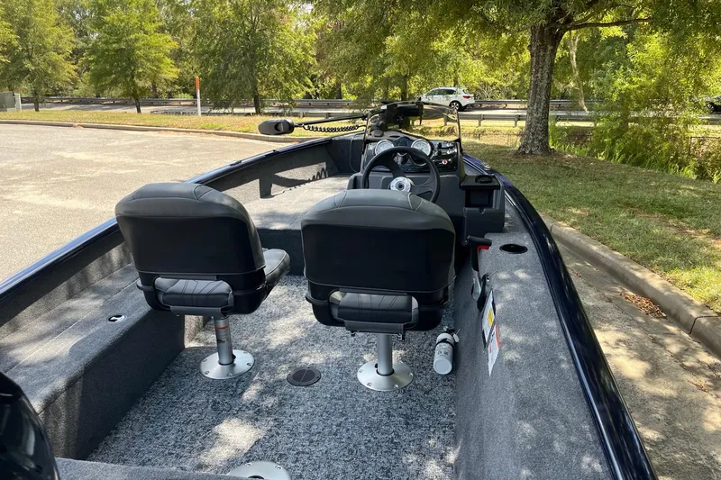 Slide: The Image of 2026 Tracker Super Guide V-16 SC boat interior with dual seats and steering console. - 5