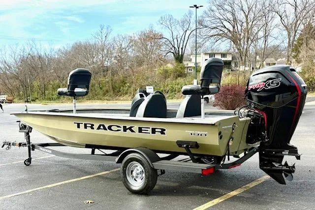 Slide: The Image of 2026 Tracker Pro Team 190 boat with outboard motor in a parking lot. - 11