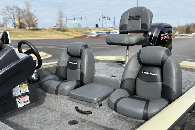 Slide: The Image of 2026 Tracker Pro Team 190 boat interior with gray seating and steering wheel. - 13