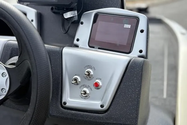Slide: The Image of Control panel of 2026 Tracker Pro Team 190 boat with switches and display screen. - 18