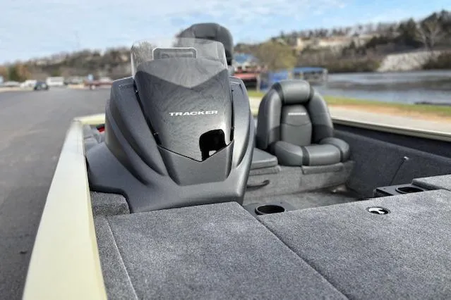 Slide: The Image of 2026 Tracker Pro Team 190 boat interior with seating and console, near a scenic waterfront. - 21