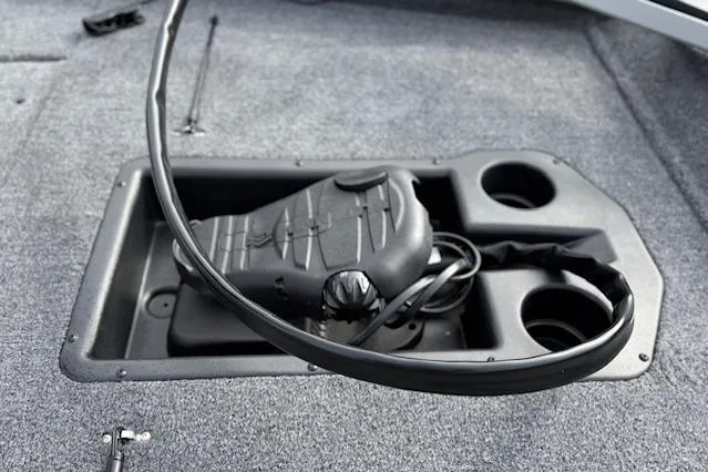 Slide: The Image of 2026 Tracker Pro Team 190 boat foot pedal and cup holders on carpeted deck. - 23