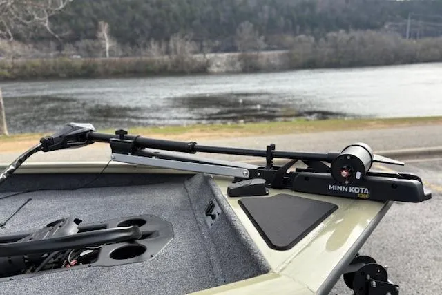 Slide: The Image of 2026 Tracker Pro Team 190 boat with Minn Kota trolling motor by a lake. - 24