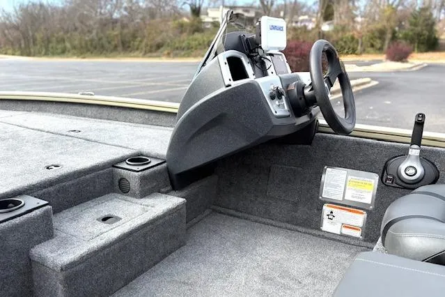 Slide: The Image of 2026 Tracker Pro Team 190 boat interior with steering console and seating. - 26