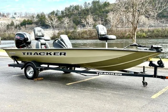 Slide: The Image of 2026 Tracker Pro Team 190 boat on trailer by a riverbank. - 5