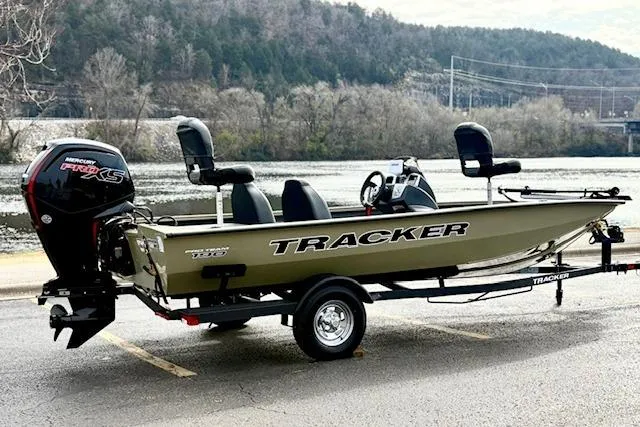 Slide: The Image of 2026 Tracker Pro Team 190 boat on trailer by a scenic river. - 6