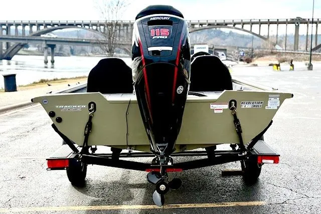Slide: The Image of 2026 Tracker Pro Team 190 boat with Mercury 115 Pro XS engine, parked near a bridge. - 7