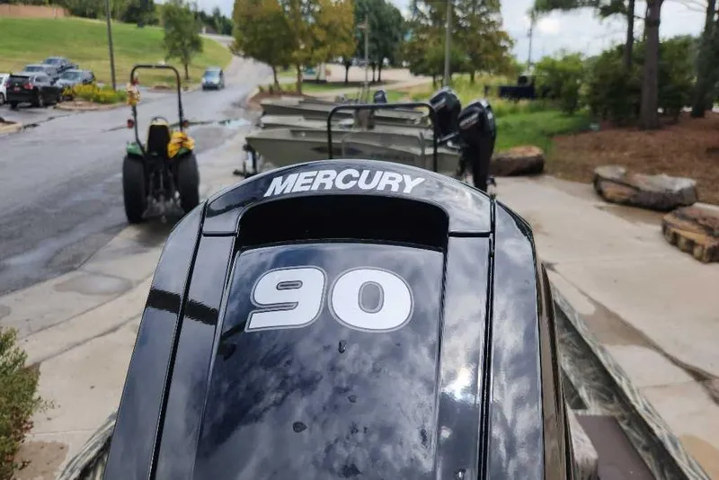 Slide: The Image of Mercury 90 horsepower engine on 2026 Tracker Grizzly 1860 CC boat, parked outdoors. - 65