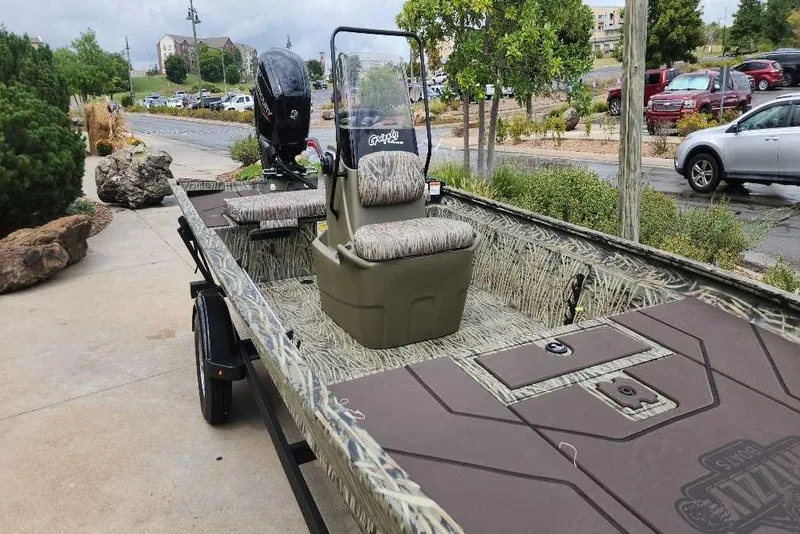 Slide: The Image of 2026 Tracker Grizzly 1860 CC boat with camouflage design on a trailer. - 68