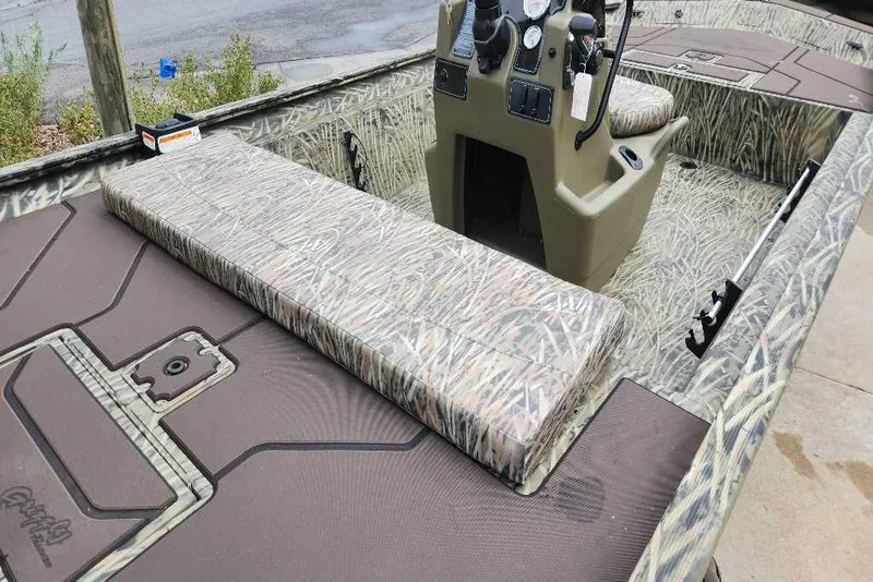 Slide: The Image of 2026 Tracker Grizzly 1860 CC boat interior with camouflage seating and console. - 70